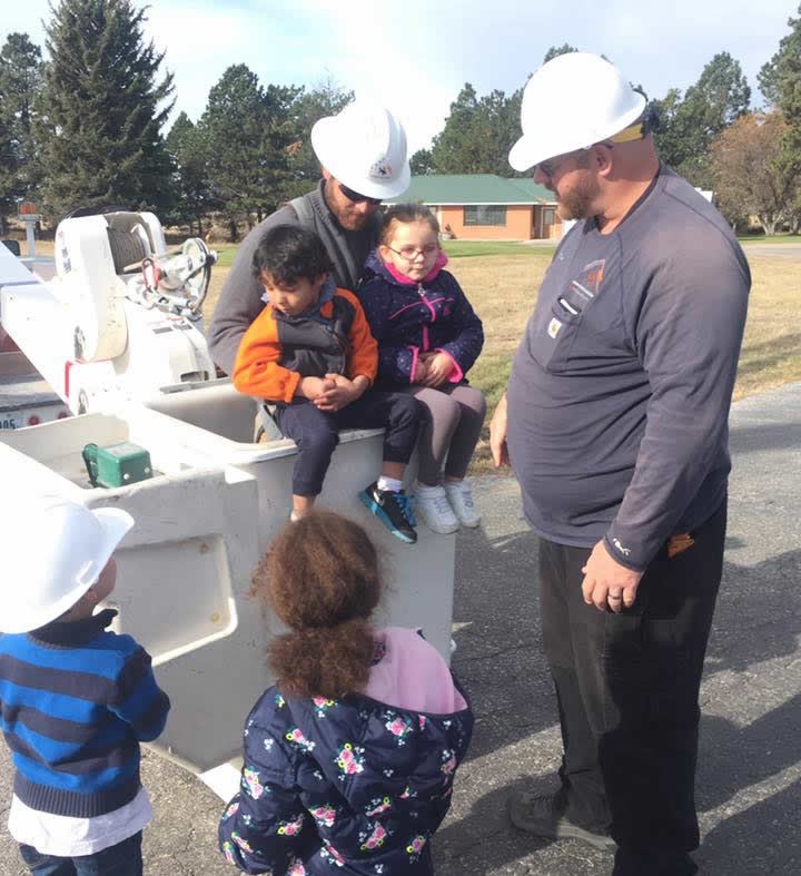 Levi and Doug with kids and a bucket truck